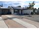 Inviting single-story house with solar panels, a spacious driveway, and a covered parking area at 109 Ash St, Henderson, NV 89015
