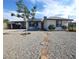 Single-story home with solar panels, well-kept landscaping, and a stone walkway at 109 Ash St, Henderson, NV 89015