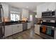 Bright kitchen featuring stainless steel appliances and white cabinets at 109 Ash St, Henderson, NV 89015