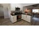 Open concept kitchen featuring white cabinets and stainless steel appliances at 109 Ash St, Henderson, NV 89015