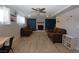 Spacious living room with modern flooring, ceiling fan, and a cozy fireplace at 109 Ash St, Henderson, NV 89015