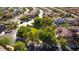 Elevated view of home in the neighborhood, situated near a grassy common area and walking paths at 12021 La Palmera Ave, Las Vegas, NV 89138