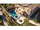 Aerial view of private backyard featuring a sparkling pool, spa, patio, and lush landscaping at 12021 La Palmera Ave, Las Vegas, NV 89138