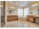 Luxurious bathroom featuring tiled floors, a corner tub, double vanity sinks and a glass shower at 12021 La Palmera Ave, Las Vegas, NV 89138