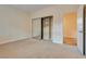 Carpeted bedroom featuring a mirrored closet, built-in shelving, and an open doorway to the hall at 12021 La Palmera Ave, Las Vegas, NV 89138