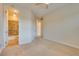 Inviting bedroom with neutral walls, carpet flooring and ensuite bathroom at 12021 La Palmera Ave, Las Vegas, NV 89138