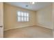 Bright, carpeted bedroom with natural light from the window and plantation shutters providing a comfortable space at 12021 La Palmera Ave, Las Vegas, NV 89138