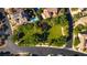 Aerial view of a common grassy space with walking paths, trees, and neighborhood homes at 12021 La Palmera Ave, Las Vegas, NV 89138
