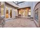 Open-air courtyard featuring stone floors, stucco walls, and a cozy fireplace, perfect for outdoor relaxation and entertainment at 12021 La Palmera Ave, Las Vegas, NV 89138