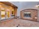Relaxing tiled courtyard featuring an inviting stone fireplace, offering an ideal space for outdoor living and entertaining at 12021 La Palmera Ave, Las Vegas, NV 89138