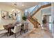 Formal dining room with staircase, chandelier, and seating for six at a long wooden table at 12021 La Palmera Ave, Las Vegas, NV 89138
