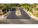 Community entrance featuring secure gates, mature landscaping, and attractive signage at 12021 La Palmera Ave, Las Vegas, NV 89138
