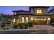 Elegant two-story home featuring desert landscaping, a stone-accented entry, and an attached two-car garage at 12021 La Palmera Ave, Las Vegas, NV 89138