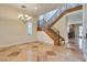 Foyer featuring staircase with iron railing and decorative chandelier at 12021 La Palmera Ave, Las Vegas, NV 89138