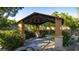 Attractive gazebo with a seat surrounded by lush landscaping in this outdoor community park at 12021 La Palmera Ave, Las Vegas, NV 89138