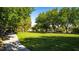 Picturesque view of a lush, grassy park featuring benches, trees, and walking path at 12021 La Palmera Ave, Las Vegas, NV 89138