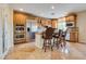 Kitchen with stainless steel appliances, island with seating, and tile floors at 12021 La Palmera Ave, Las Vegas, NV 89138