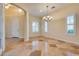 Living room with tile floor, multiple windows, and chandelier at 12021 La Palmera Ave, Las Vegas, NV 89138