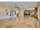 Open living area with tile floors, ceiling fan and view to kitchen at 12021 La Palmera Ave, Las Vegas, NV 89138