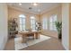 Bright home office with tray ceiling, modern desk, and large windows with shutter details at 12021 La Palmera Ave, Las Vegas, NV 89138