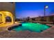 Inviting backyard pool and spa with tiered waterfalls and beautiful landscaping at dusk at 12021 La Palmera Ave, Las Vegas, NV 89138