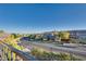 View from balcony featuring street with landscaped median, other houses and distant mountains at 12021 La Palmera Ave, Las Vegas, NV 89138