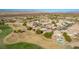 This is a wide aerial shot of a neighborhood adjacent to a golf course, backed by desert and mountain scenery at 1441 Palm Dr, Laughlin, NV 89029