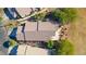 An aerial view of a house with a brown roof and well-manicured backyard surrounded by lush greenery at 1441 Palm Dr, Laughlin, NV 89029
