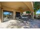 Covered patio with sliding glass doors and ceiling fan, featuring outdoor furniture and a serene atmosphere at 1441 Palm Dr, Laughlin, NV 89029