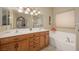 Bright bathroom featuring dual sinks, large soaking tub, and stylish fixtures at 1441 Palm Dr, Laughlin, NV 89029