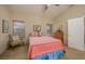 Cozy bedroom featuring carpet, ample natural light, and coordinated Southwestern-themed bed linens at 1441 Palm Dr, Laughlin, NV 89029
