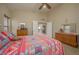 Comfortable bedroom featuring a ceiling fan, carpet, and coordinated Southwestern-themed bed linens at 1441 Palm Dr, Laughlin, NV 89029