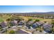 Beautiful desert homes with front-facing garages overlooking a lush golf course on a sunny day at 1441 Palm Dr, Laughlin, NV 89029