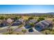 Beautiful desert homes with front-facing garages overlooking a lush golf course on a sunny day at 1441 Palm Dr, Laughlin, NV 89029