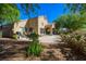 Home exterior features a covered patio, lush landscaping, and a dining area at 1441 Palm Dr, Laughlin, NV 89029