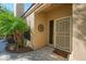 Close-up of the front door with a security screen and desert landscaping at 1441 Palm Dr, Laughlin, NV 89029