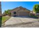 Charming single-story home with desert landscaping, a spacious driveway, and a two-car garage at 1441 Palm Dr, Laughlin, NV 89029