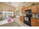 Kitchen features stainless appliances, granite countertops, tile backsplashes, and oak cabinetry at 1441 Palm Dr, Laughlin, NV 89029