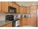 The kitchen features oak cabinets, stainless appliances, granite counters and breakfast bar at 1441 Palm Dr, Laughlin, NV 89029