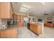 Open kitchen features tiled floors and counter tops with stainless appliances and ample storage at 1441 Palm Dr, Laughlin, NV 89029