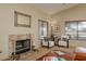Living room with a fireplace, large windows and two chairs at 1441 Palm Dr, Laughlin, NV 89029
