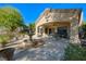 Covered patio features a dining area, ceiling fan, and decorative fountain, perfect for outdoor entertaining at 1441 Palm Dr, Laughlin, NV 89029