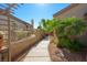 Landscaped side yard featuring a mix of desert plants and a paved walkway at 1441 Palm Dr, Laughlin, NV 89029