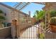 A tranquil side yard featuring a decorative arbor, cacti, and drought-tolerant plants at 1441 Palm Dr, Laughlin, NV 89029