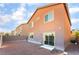 Spacious backyard with rock groundcover, privacy fence, and sliding door access to indoor living spaces at 1512 Groom Ave, North Las Vegas, NV 89081