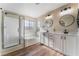 Bright bathroom featuring double sinks, soaking tub and glass enclosed shower at 1512 Groom Ave, North Las Vegas, NV 89081