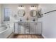 The bathroom has a soaking tub, double sink vanity, modern lighting, and sleek black fixtures at 1512 Groom Ave, North Las Vegas, NV 89081