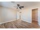 This bright bedroom features wood-look flooring, ceiling fan, neutral paint, and an attached walk-in closet at 1512 Groom Ave, North Las Vegas, NV 89081