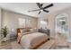 Comfortable bedroom with neutral decor, a ceiling fan and ensuite bath at 1512 Groom Ave, North Las Vegas, NV 89081