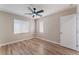 Bedroom featuring wood-look flooring, large window and a closet at 1512 Groom Ave, North Las Vegas, NV 89081